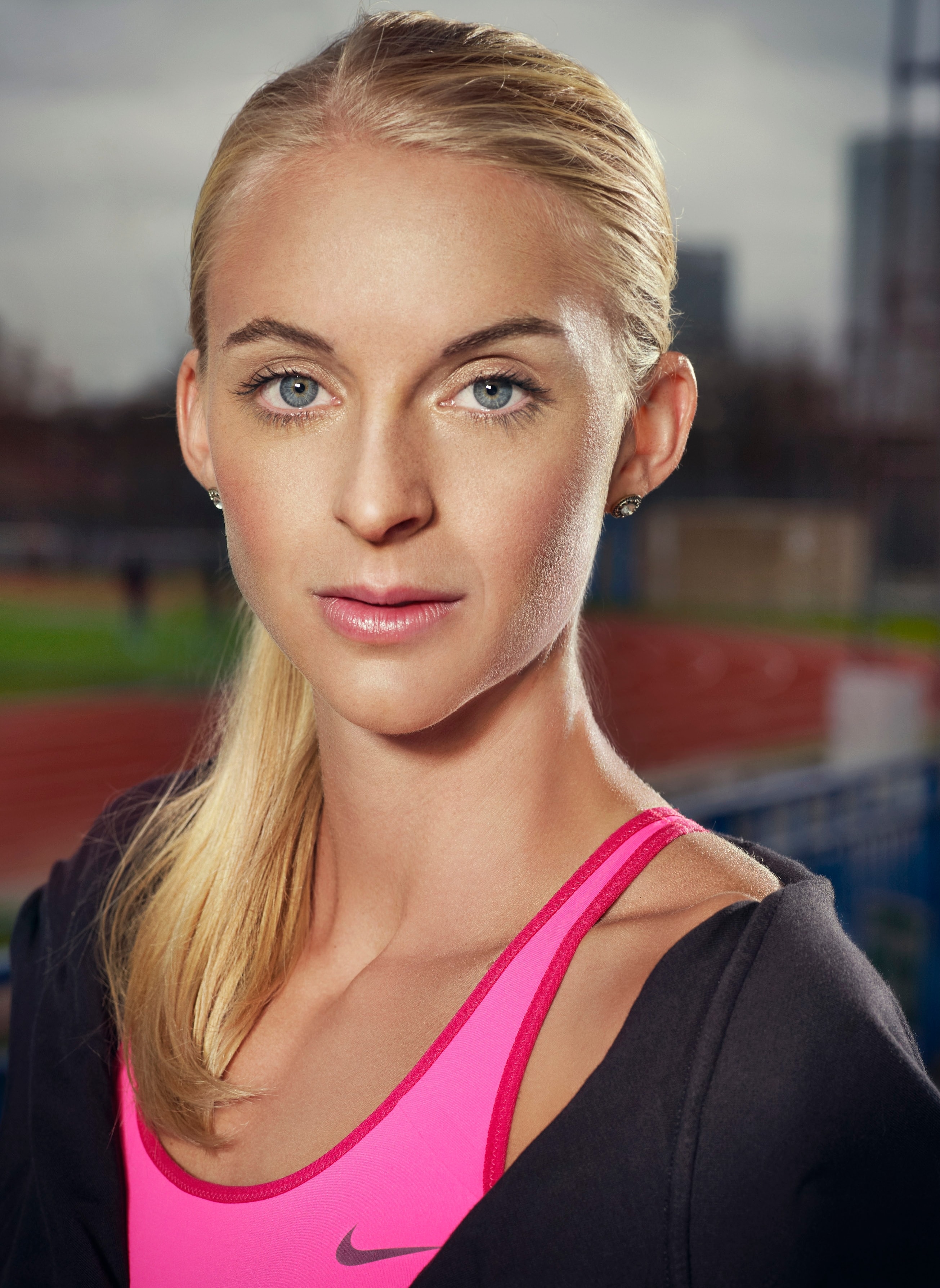 Athletic beauty portrait — natural glam, sleek ponytail, pink Nike sport top